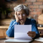 Medicare card and monthly premium paperwork on a desk