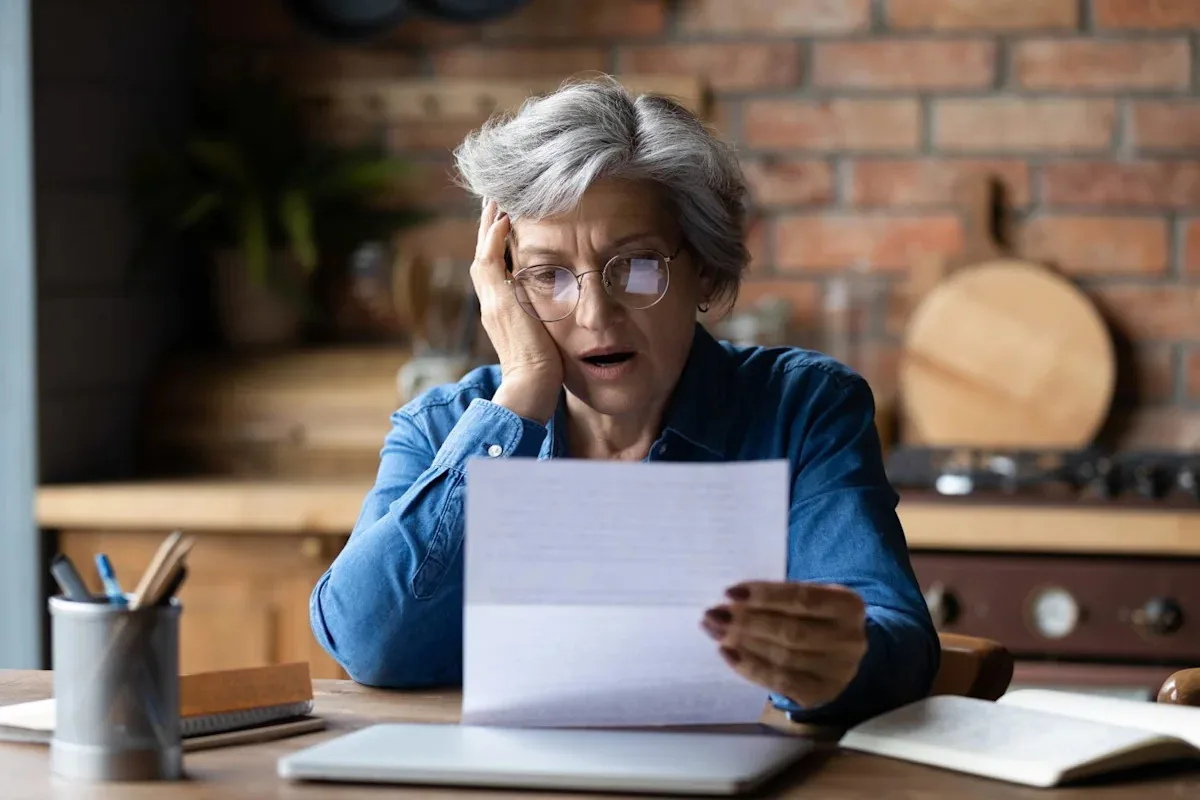 Medicare card and monthly premium paperwork on a desk